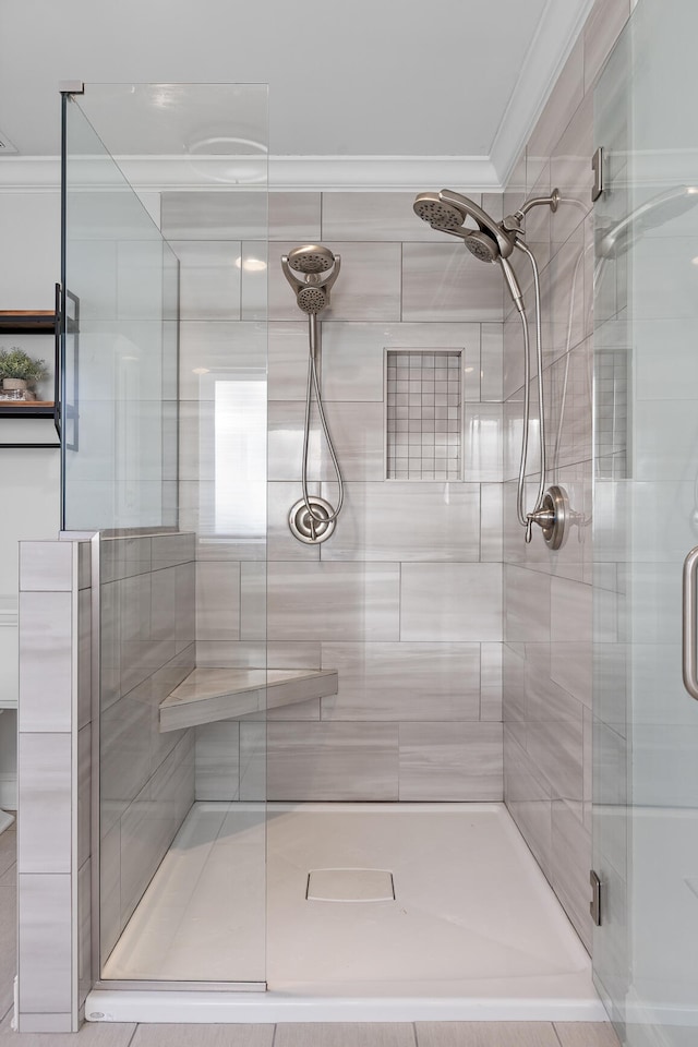 bathroom with ornamental molding and walk in shower