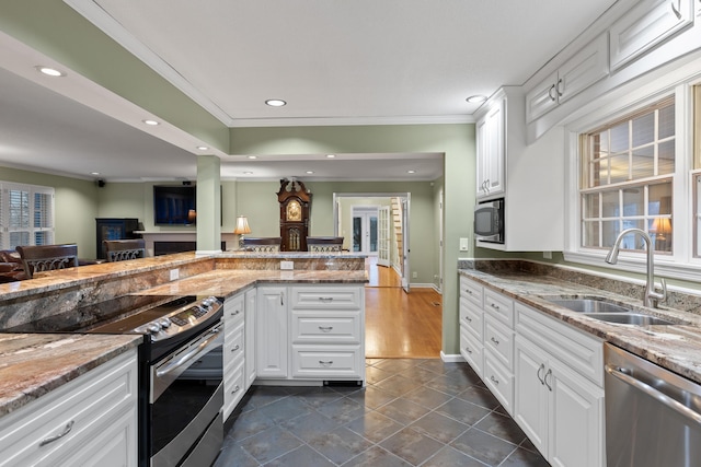 kitchen with white cabinetry, appliances with stainless steel finishes, and sink