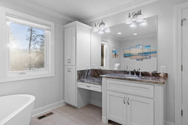 bathroom featuring a bathtub, an inviting chandelier, tile patterned floors, crown molding, and vanity