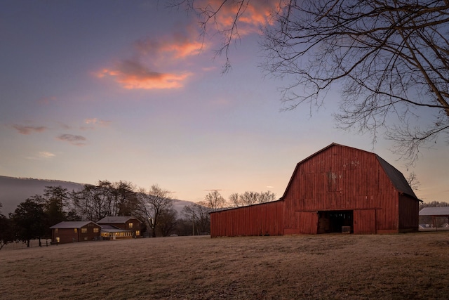 yard at dusk with a mountain view and an outbuilding