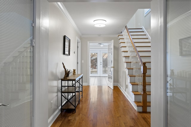 corridor featuring ornamental molding, french doors, and hardwood / wood-style flooring