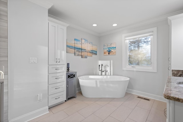 bathroom with a tub to relax in, crown molding, vanity, and tile patterned floors