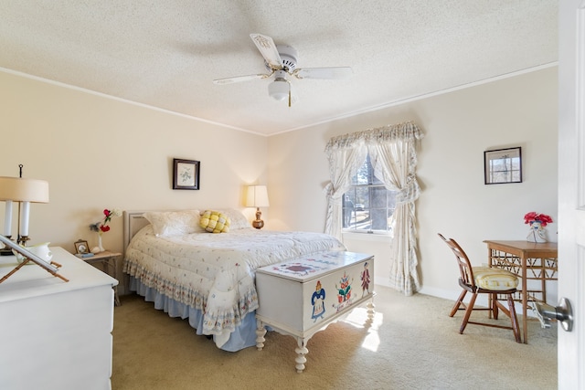 carpeted bedroom featuring ornamental molding, ceiling fan, and a textured ceiling