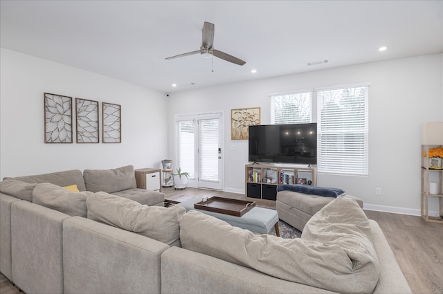 living room with ceiling fan and light hardwood / wood-style floors