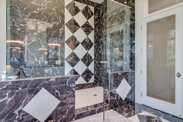 bathroom featuring walk in shower and tile walls