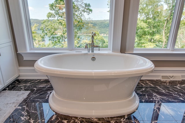 bathroom featuring tile flooring and a wealth of natural light