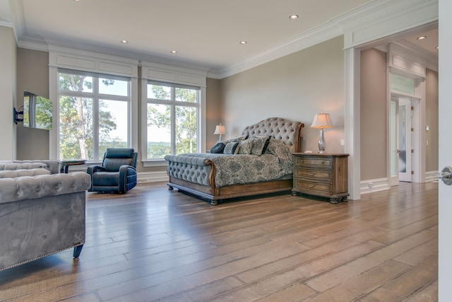 bedroom with ornamental molding and wood-type flooring