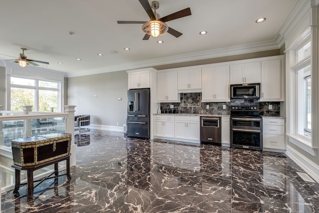 kitchen featuring ceiling fan, sink, stainless steel appliances, light stone countertops, and white cabinetry