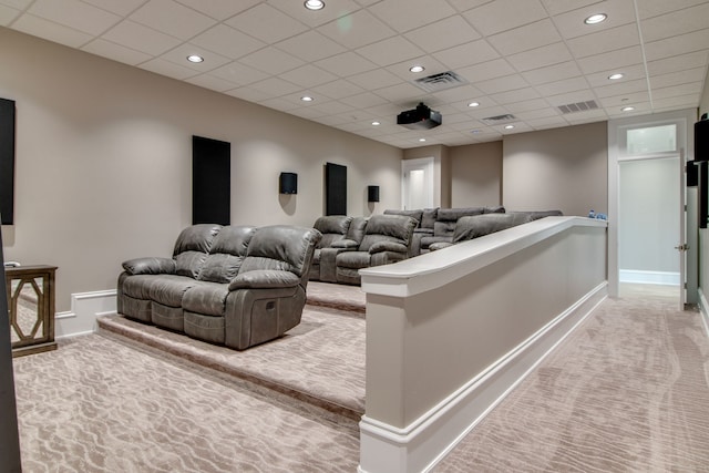 carpeted cinema featuring a drop ceiling