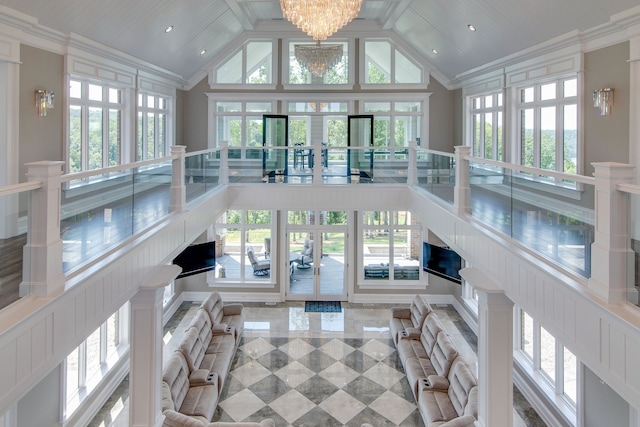 sunroom / solarium featuring an inviting chandelier and vaulted ceiling