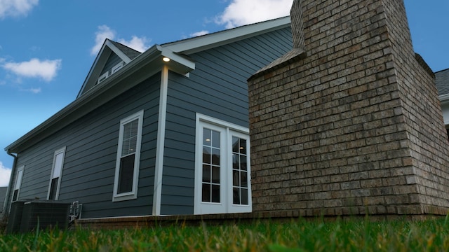 view of side of home with french doors and central AC unit