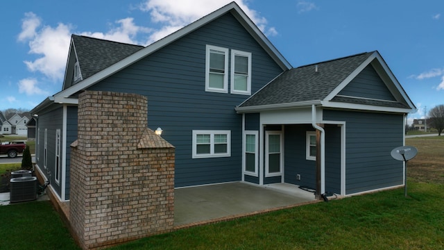 rear view of property featuring central AC, a yard, and a patio