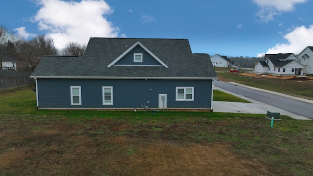 rear view of property featuring a lawn