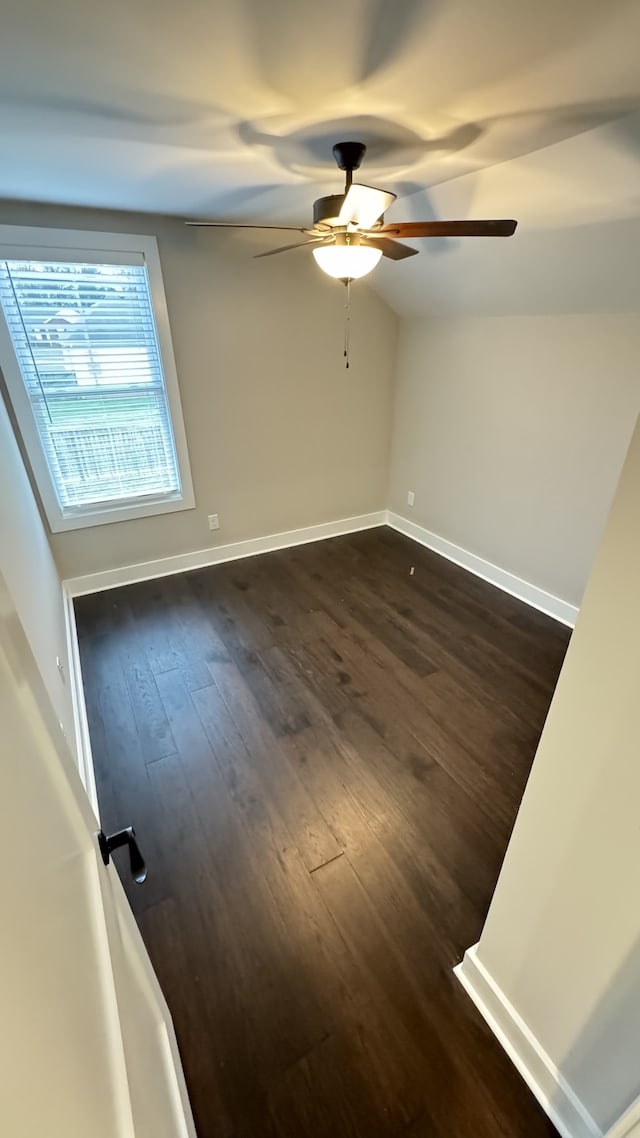 empty room with dark hardwood / wood-style flooring and ceiling fan