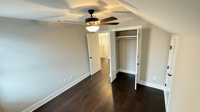 unfurnished bedroom featuring ceiling fan, a closet, lofted ceiling, and dark hardwood / wood-style floors