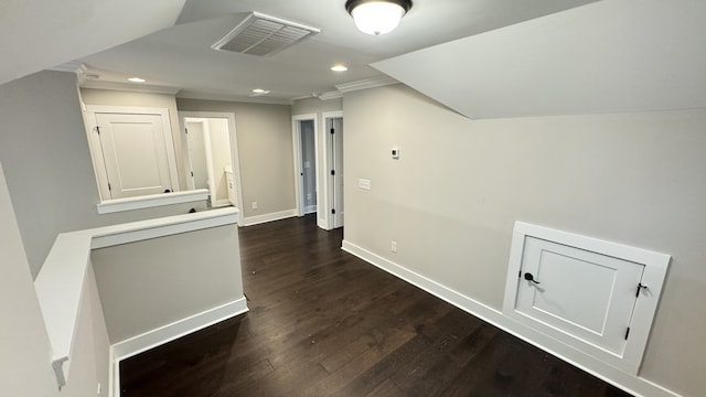 hallway featuring ornamental molding and dark hardwood / wood-style floors