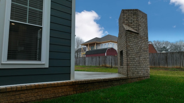 view of property exterior with a lawn and a patio