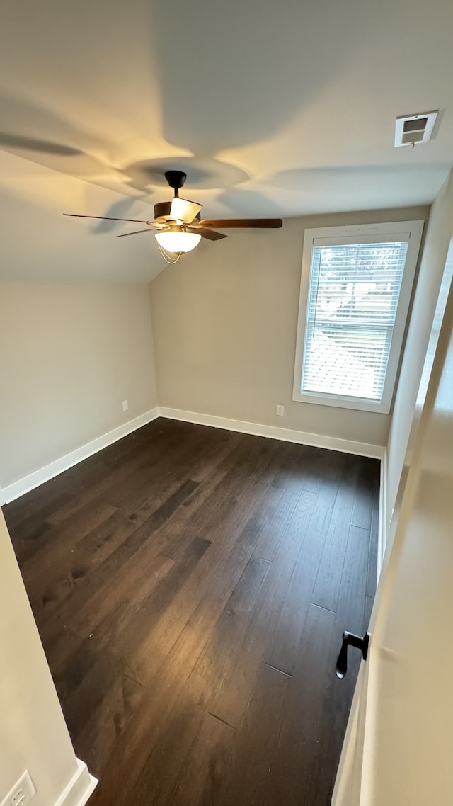 unfurnished room with ceiling fan and dark hardwood / wood-style flooring