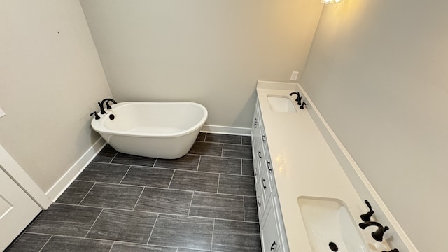 bathroom featuring a bath to relax in, tile flooring, and vanity