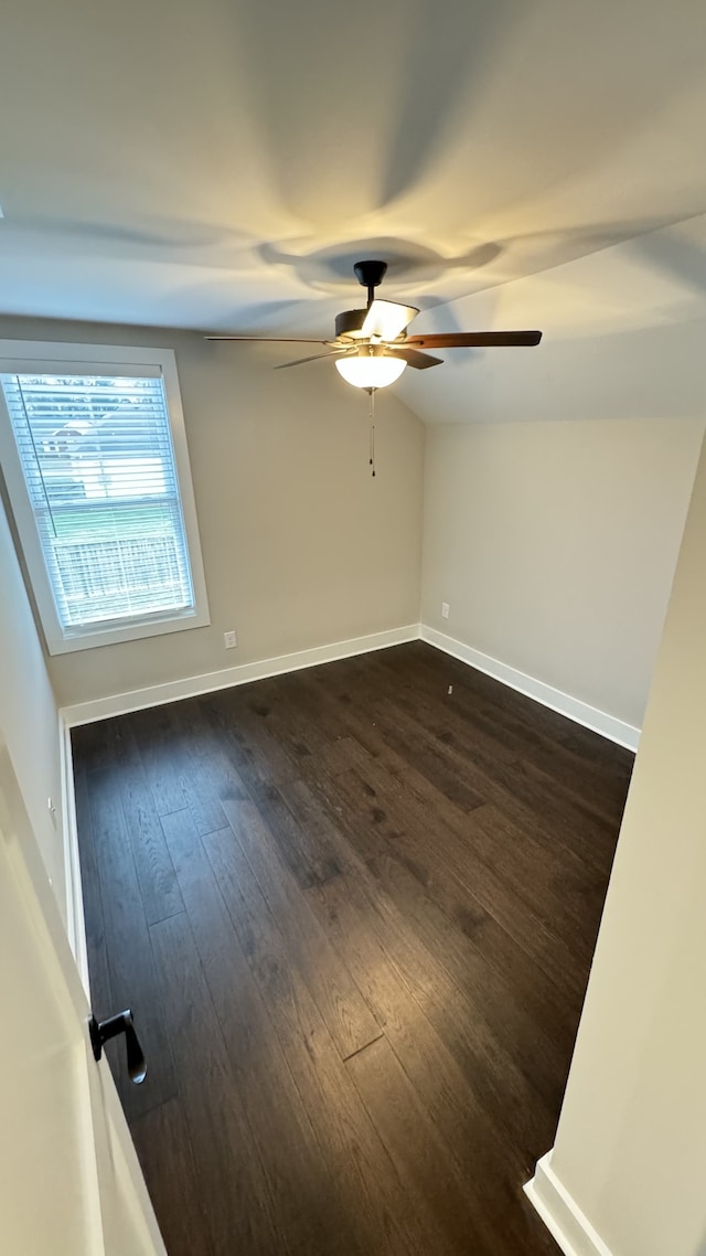 empty room with ceiling fan and dark hardwood / wood-style floors