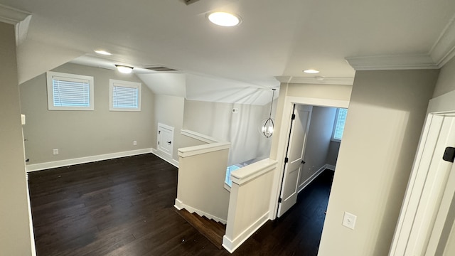 hall with ornamental molding and dark hardwood / wood-style floors