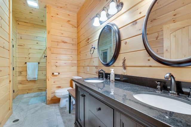 bathroom featuring wooden ceiling, wood walls, toilet, dual vanity, and tile floors