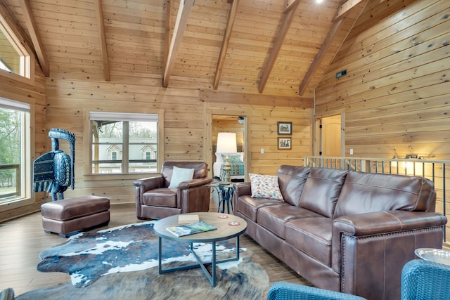 living room featuring wood walls, high vaulted ceiling, beam ceiling, wood ceiling, and light wood-type flooring