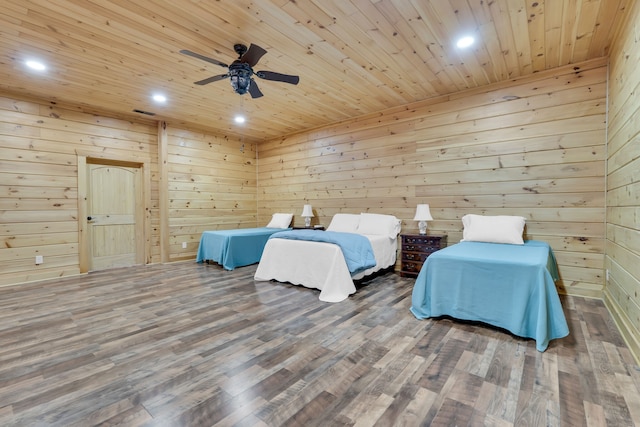 bedroom with wooden walls, wood ceiling, and dark hardwood / wood-style floors