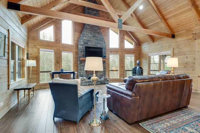 living room with beamed ceiling, wood walls, and hardwood / wood-style flooring