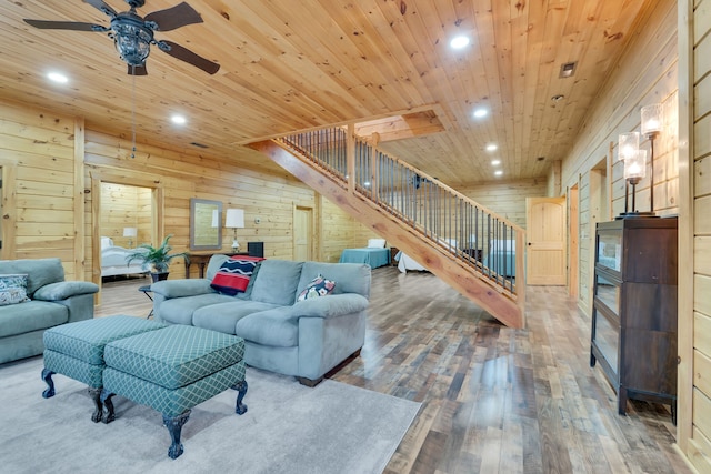 living room with wood walls, wooden ceiling, ceiling fan, and hardwood / wood-style flooring