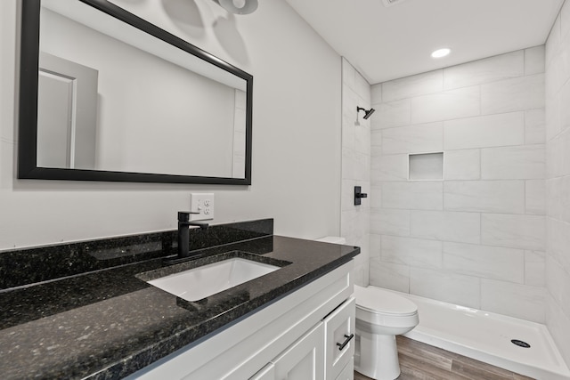 bathroom with toilet, hardwood / wood-style floors, and vanity