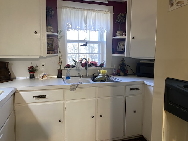 kitchen with sink and white cabinetry