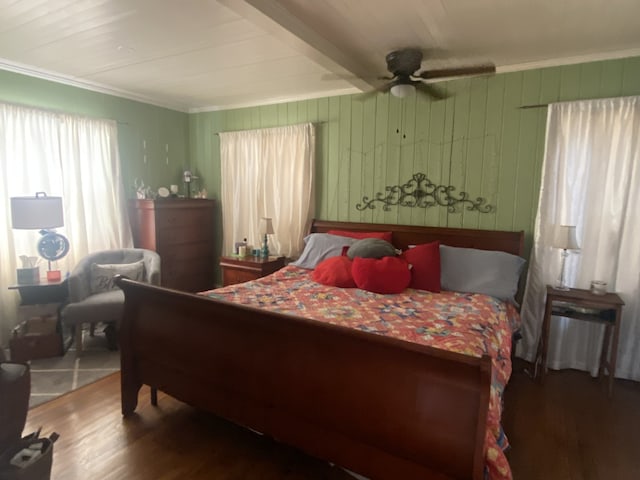 bedroom featuring beamed ceiling, dark hardwood / wood-style flooring, and ceiling fan