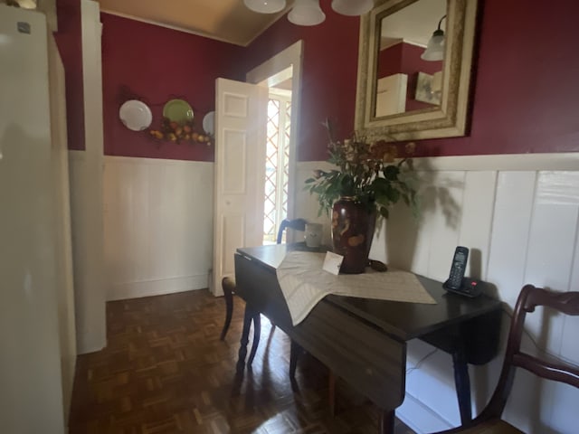 dining area featuring dark parquet flooring