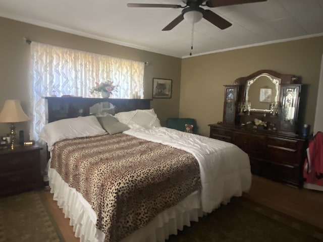 bedroom with ornamental molding, ceiling fan, and dark hardwood / wood-style floors