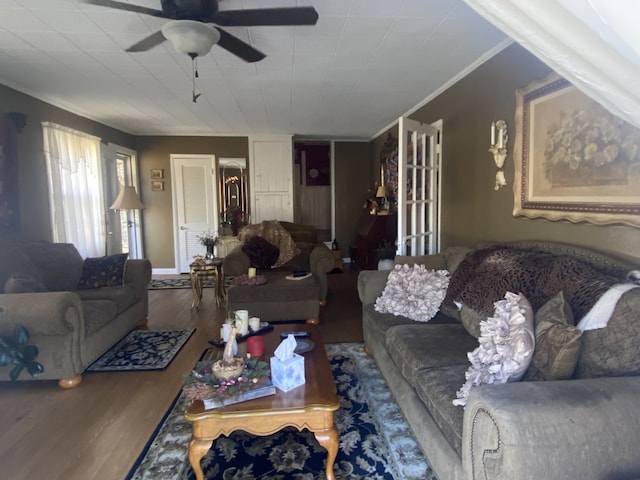 living room with ornamental molding, ceiling fan, and hardwood / wood-style flooring