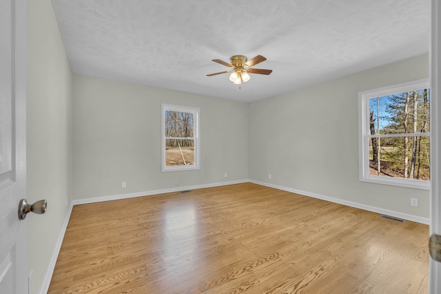 spare room featuring ceiling fan and light wood-type flooring