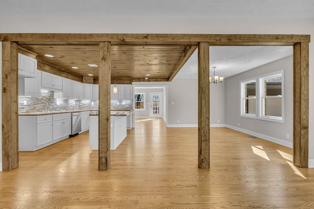 interior space with light hardwood / wood-style floors, a notable chandelier, french doors, and a wealth of natural light