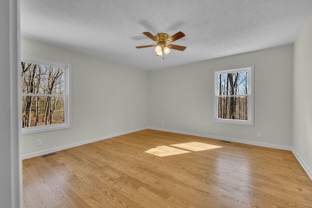 empty room with ceiling fan and light wood-type flooring