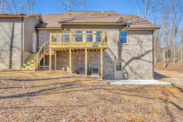 rear view of house featuring a deck and a patio area