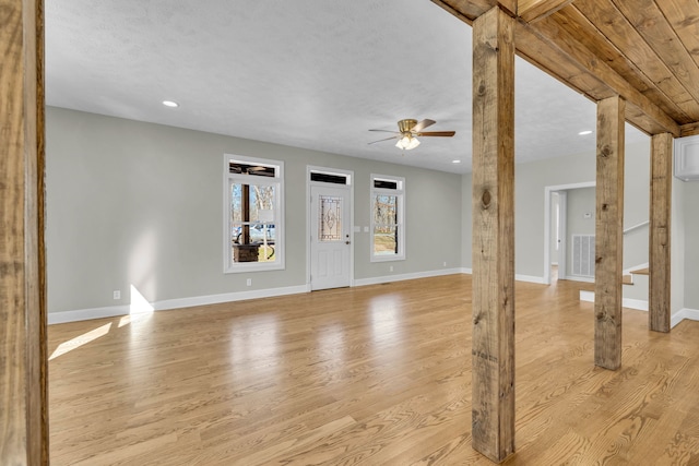 foyer entrance featuring light hardwood / wood-style floors, ceiling fan, and a textured ceiling