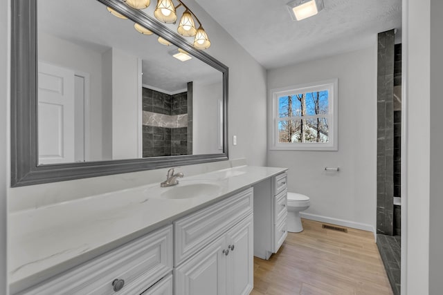 bathroom featuring hardwood / wood-style flooring, vanity, and toilet