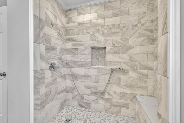 bathroom featuring a tile shower and crown molding