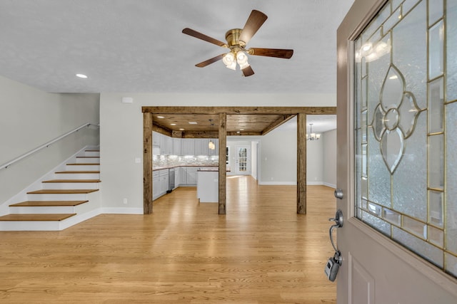 entryway featuring wood ceiling, ceiling fan with notable chandelier, and light wood-type flooring