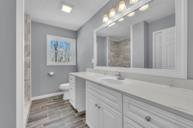 bathroom featuring tile floors, toilet, and vanity