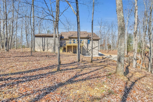 back of house with a wooden deck