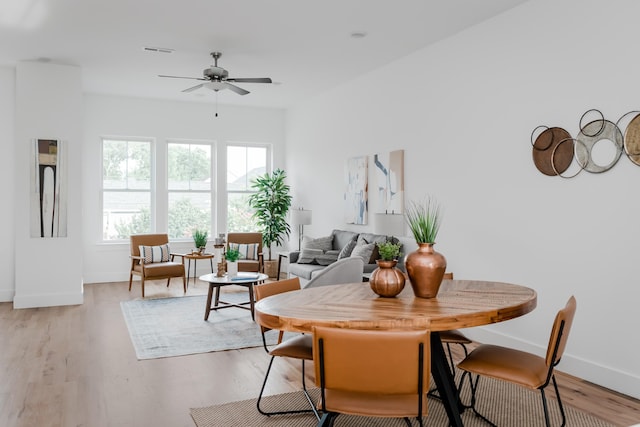 dining area featuring ceiling fan and light hardwood / wood-style floors