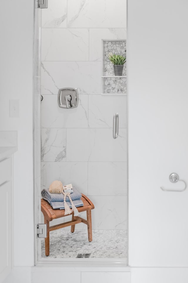 interior details featuring a shower with door