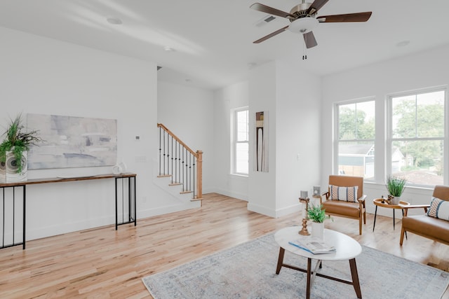 living room featuring ceiling fan and light wood-type flooring