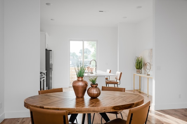 dining room featuring light hardwood / wood-style flooring and sink